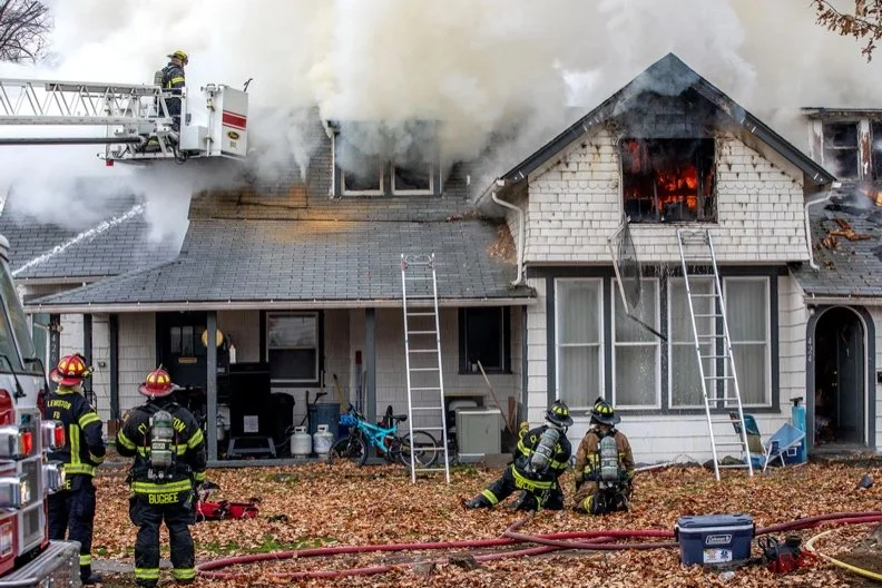 Firefighters battling a house fire.